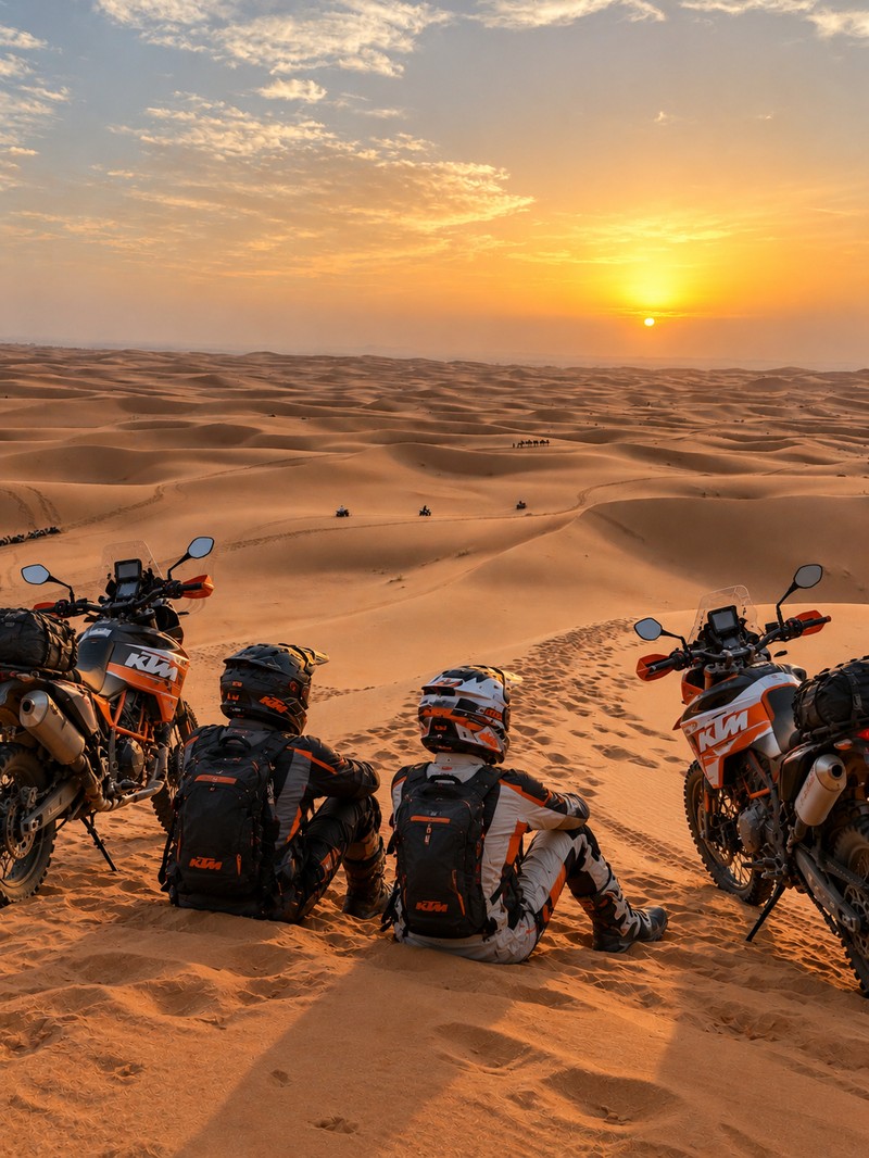 Mohamed and Elisa watching the Sahara Desert sunset on Morocco motorcycle adventure