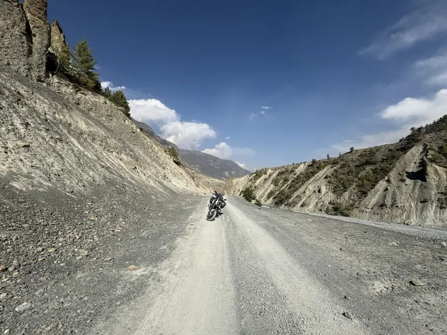 Motorcycle rider crossing high mountain pass in Morocco